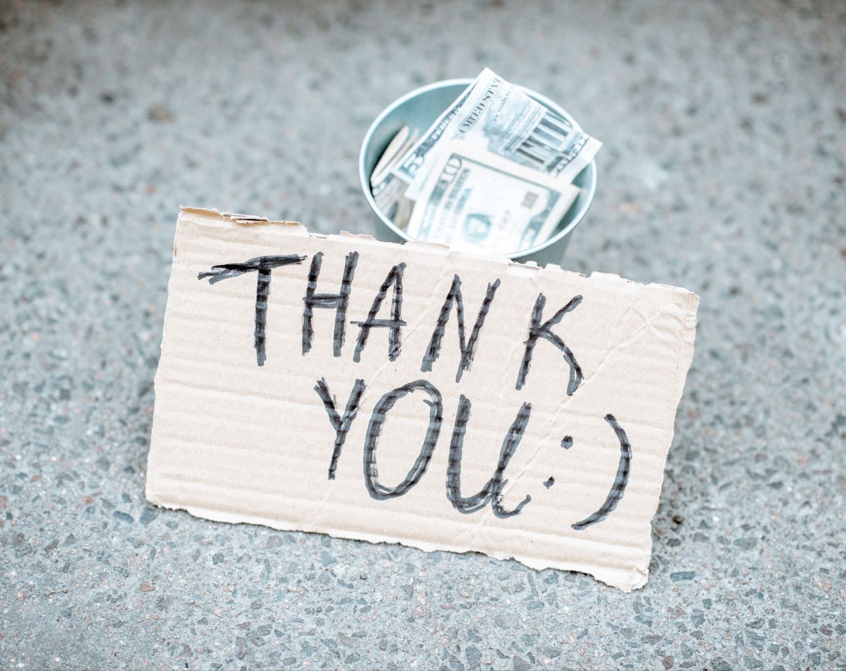 A handwritten thank you note on a piece of cardboard.